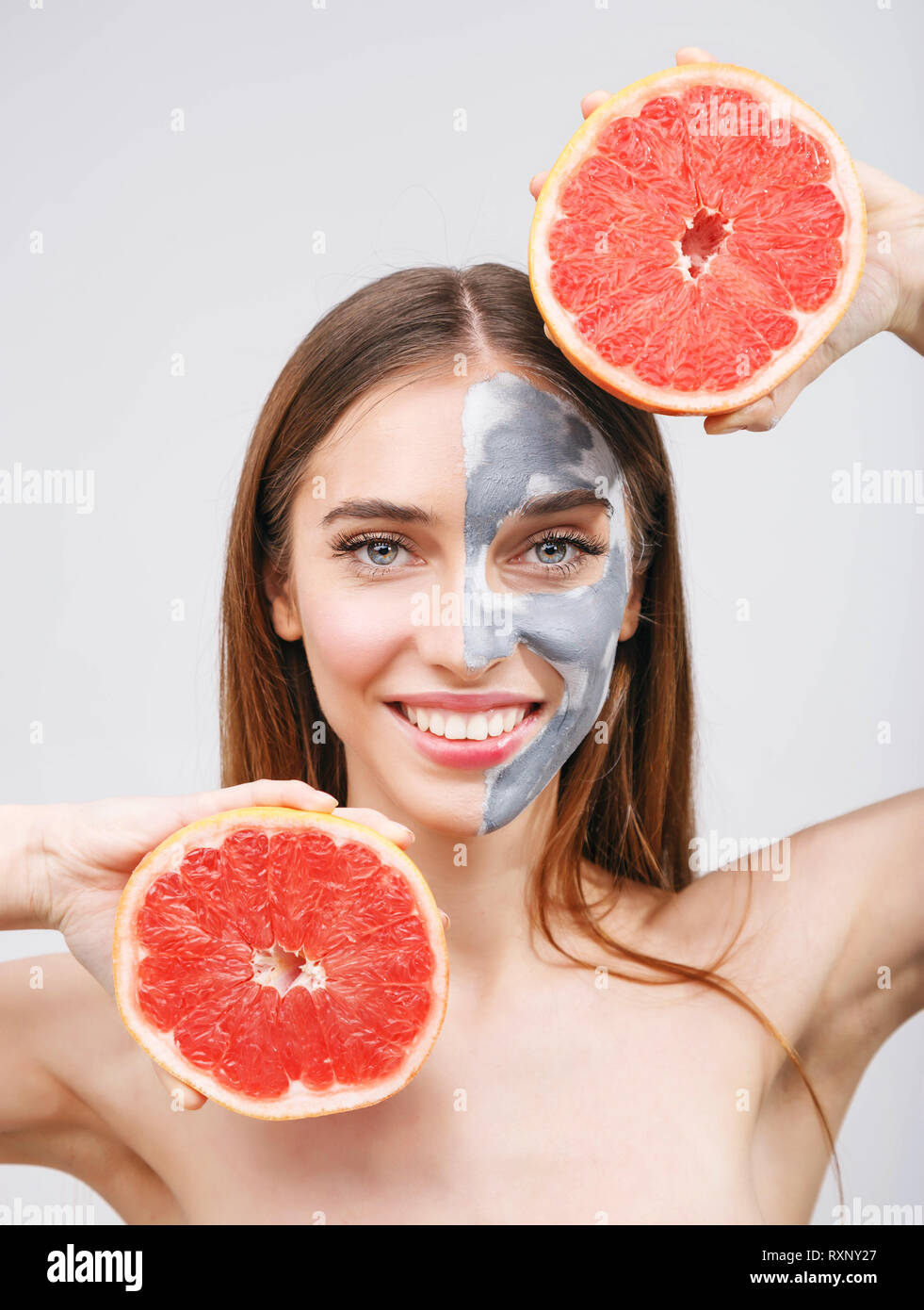 Download Beautiful Young Woman With Facial Mask And Grapefruit On White Background Stock Photo 240198063 Alamy PSD Mockup Templates