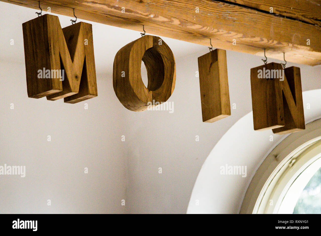 Moin! The North German greeting hangs in large letters on a wooden beam in Hotel Kavaliershaus in Fincken, Germany Stock Photo