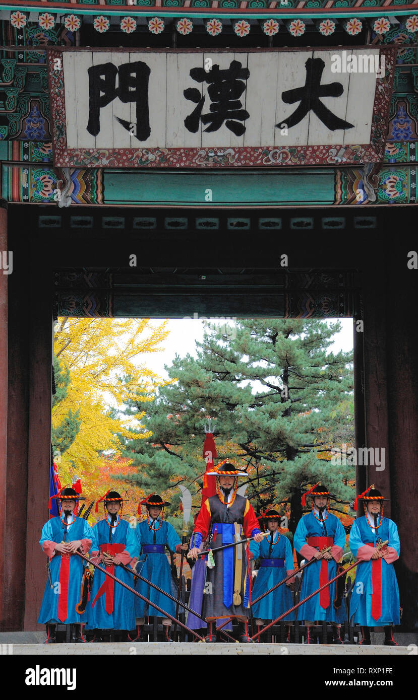 Seoul, South Korea - November 8, 2015: Armed guards in traditional costume guard the entry gate of Deoksugung Palace Stock Photo