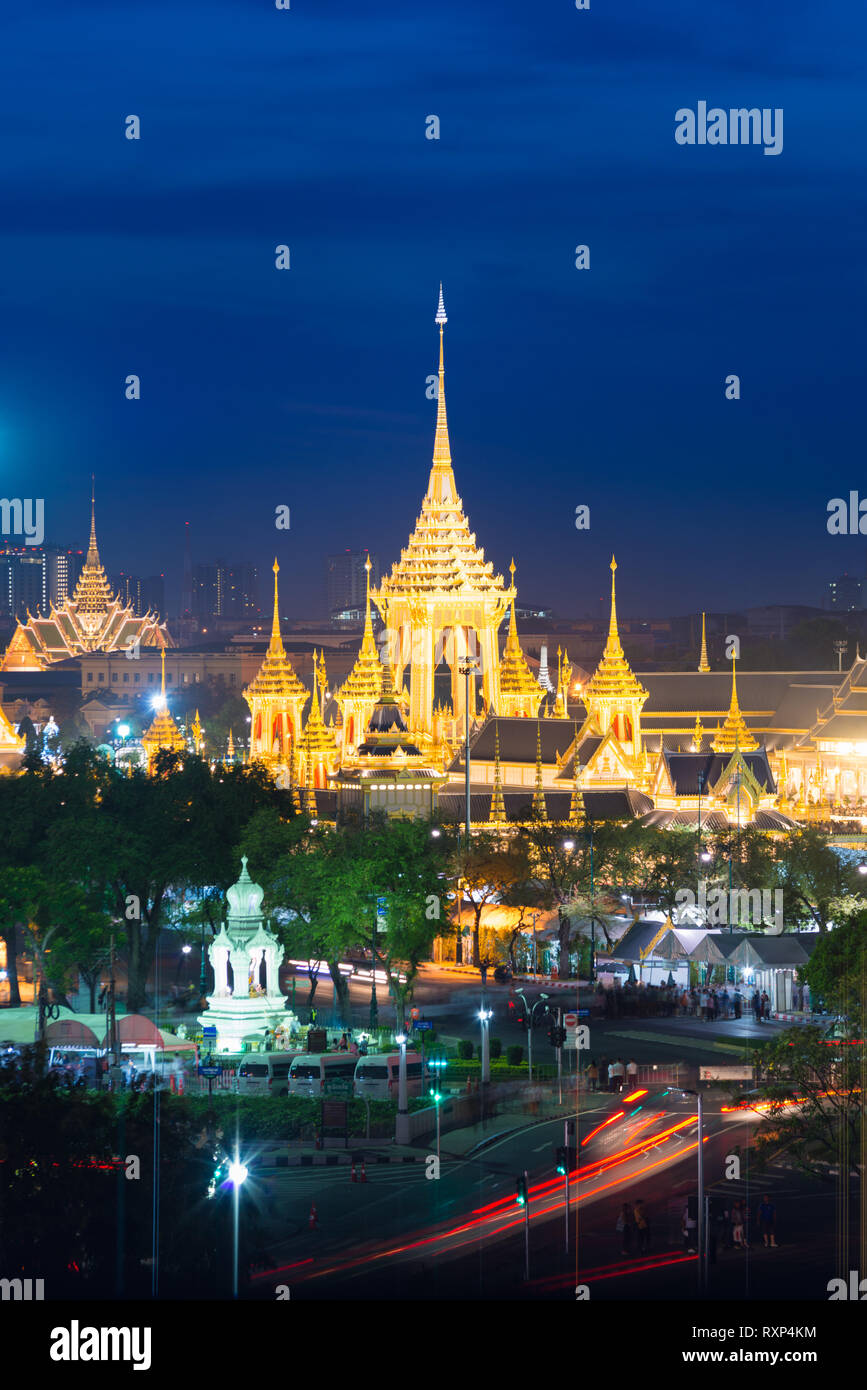 Bangkok night view from above with golden buddhist temples, chedis and night traffic Stock Photo