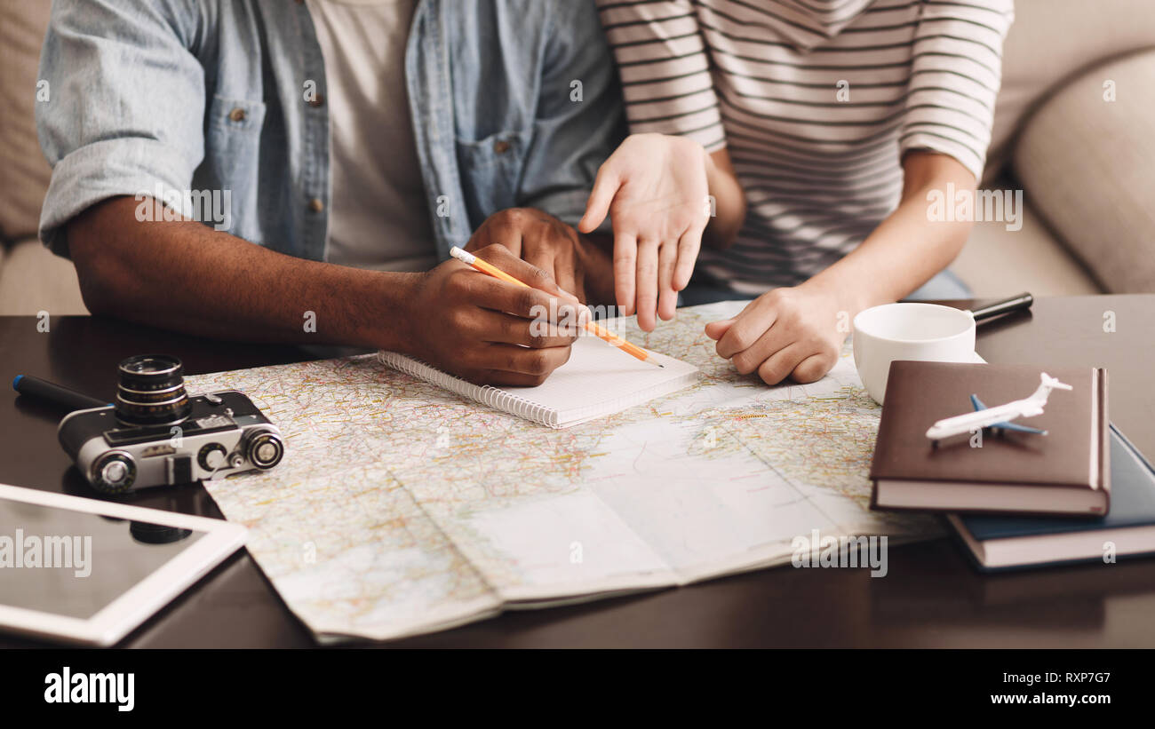 Couple planning vacation, making notes in diary Stock Photo