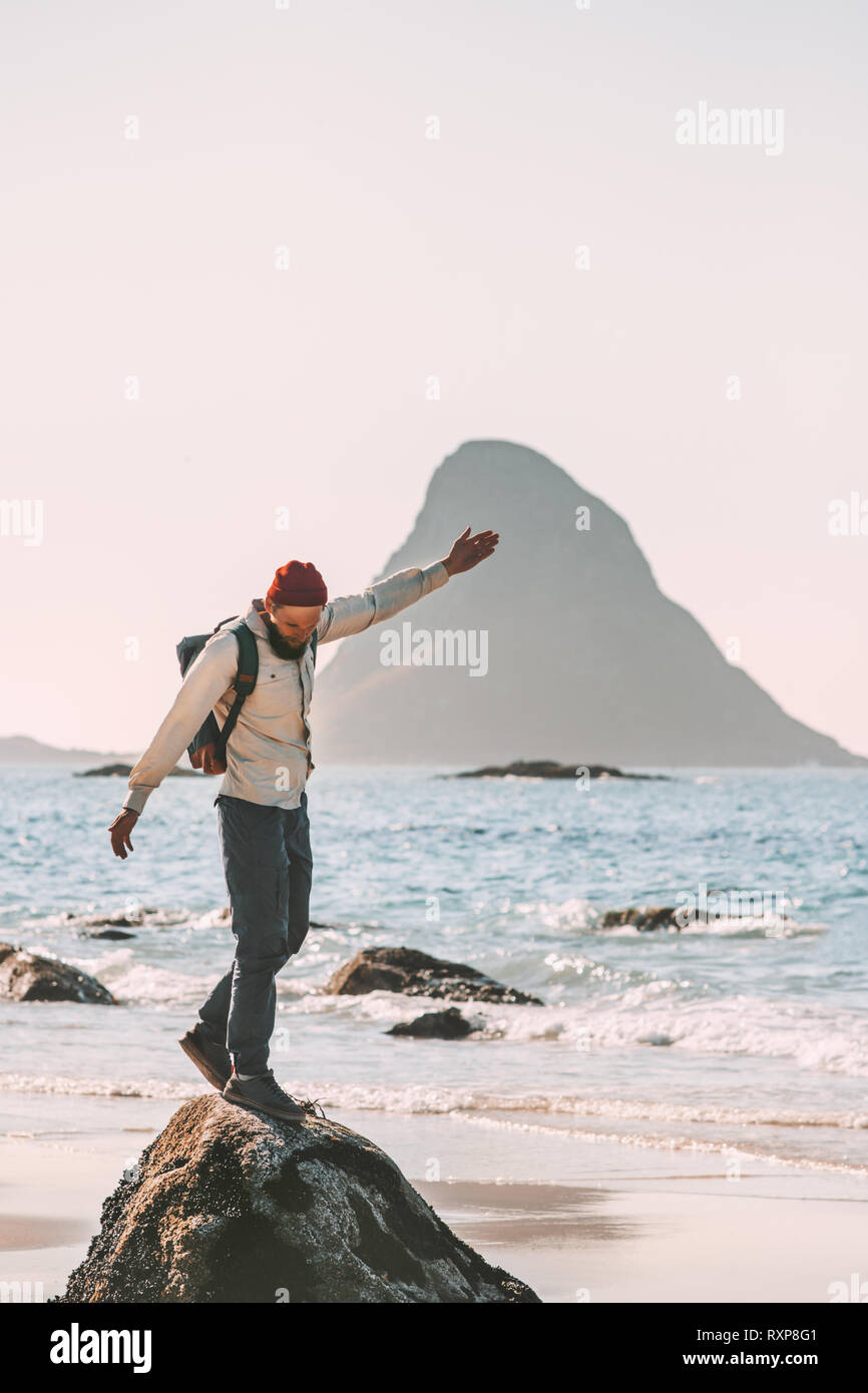 Happy man enjoying ocean beach traveling active lifestyle adventure summer vacations in Norway fun outdoor Stock Photo