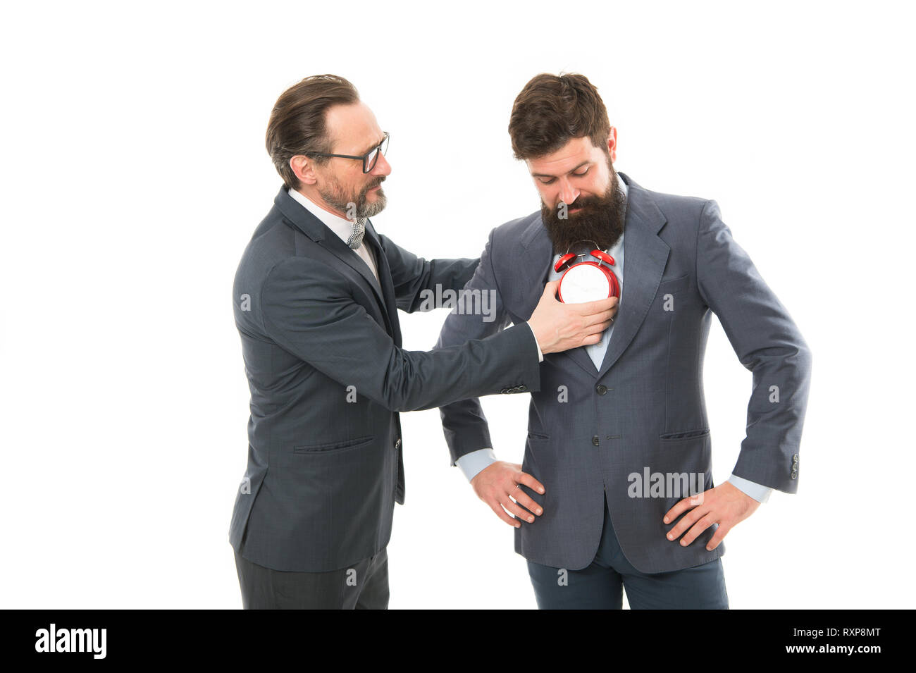 Listen your heart. Business people formal clothes with alarm clock. Time management discipline. Improve punctuality. Man experienced with clock care about time efficiency. Heart ticking. Life time. Stock Photo