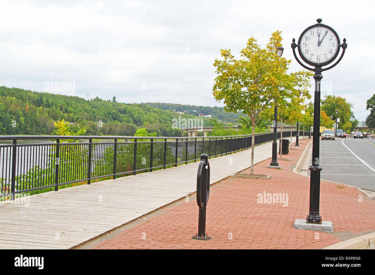 Vintage round street clock on a pole on paved bricks Stock Photo - Alamy