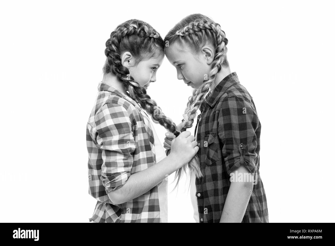 Girls friends similar hairstyle braids white background. Sisters family  look. Kanekalon hairstyle. Long hair hairstyle. Keep hairstyle braided for  healthier hair. Heart symbol made out of braids Stock Photo - Alamy