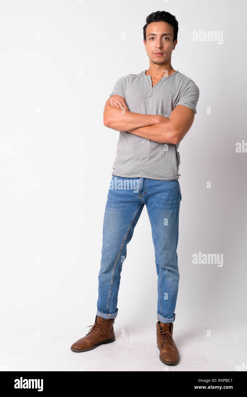Full body shot of handsome Hispanic man with arms crossed Stock Photo ...