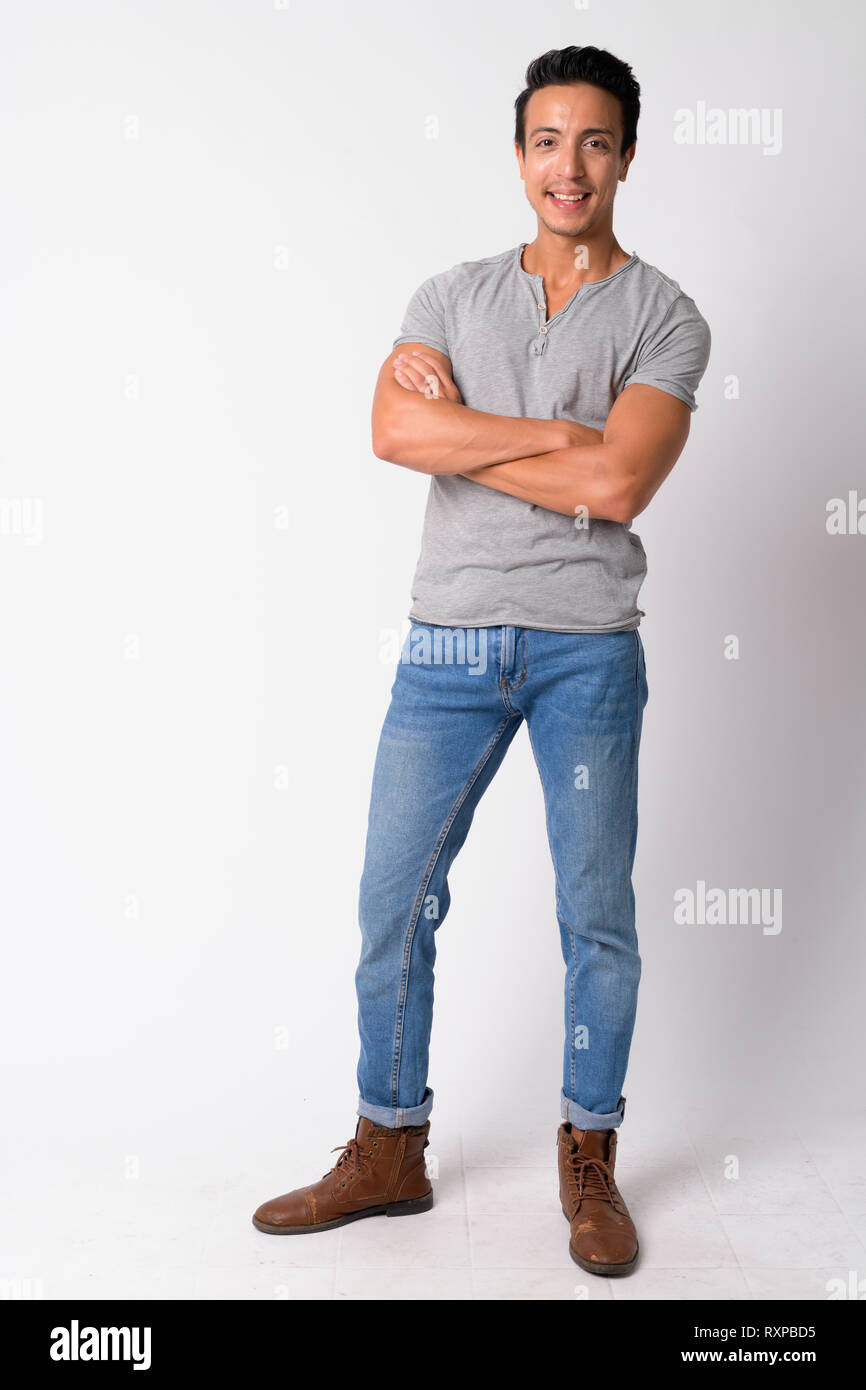 Full body shot of happy Hispanic man smiling with arms crossed Stock ...