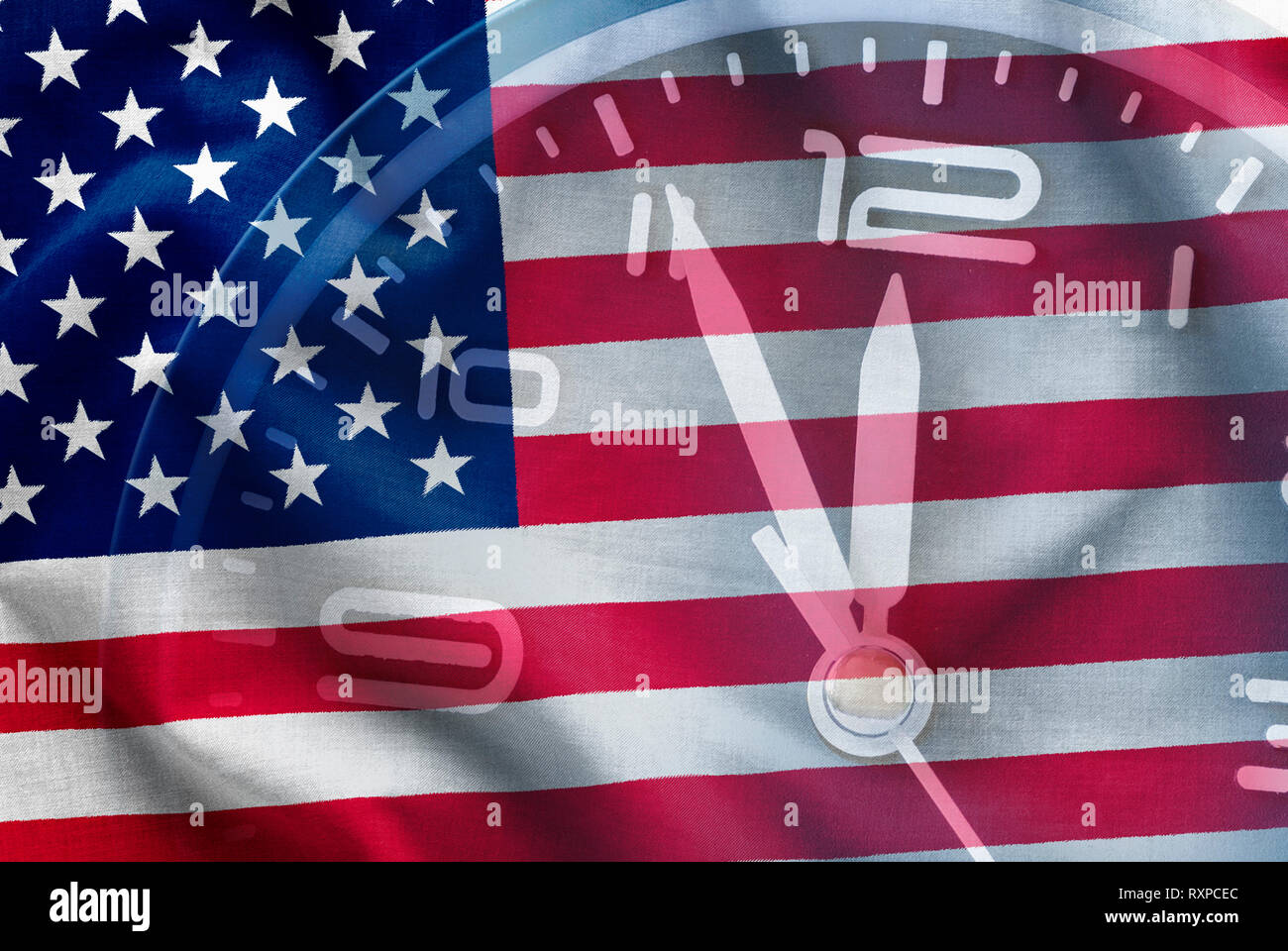 Composite of the American flag, Stars and Stripes, Old Glory, with a clock dial showing the time as five to twelve in a conceptual image Stock Photo