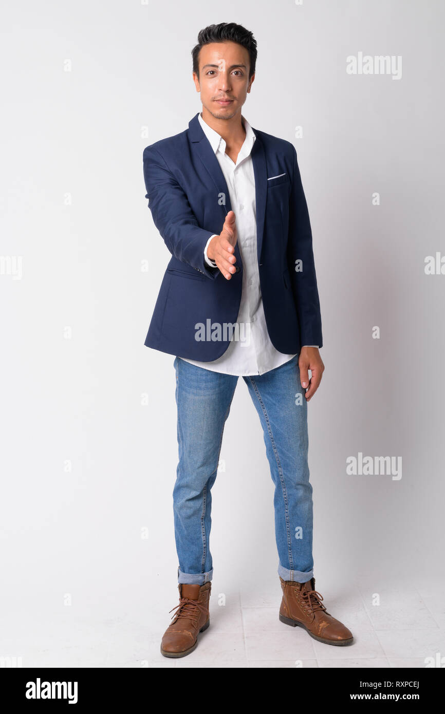 Full body shot of handsome Hispanic businessman giving handshake Stock ...