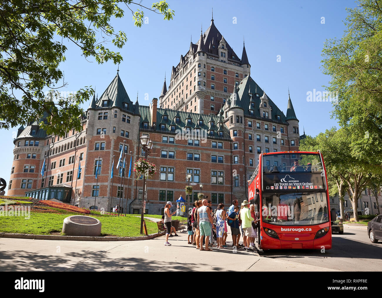 Group of tourists boarding a tour bus in front of the Chateau Frontenac in Old Quebec City, Province of Quebec, Canada Stock Photo