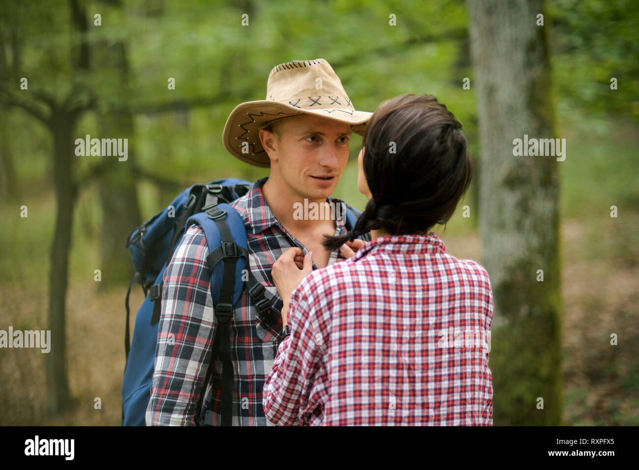 Man with woman hiking in forest. Couple in love Stock Photo - Alamy