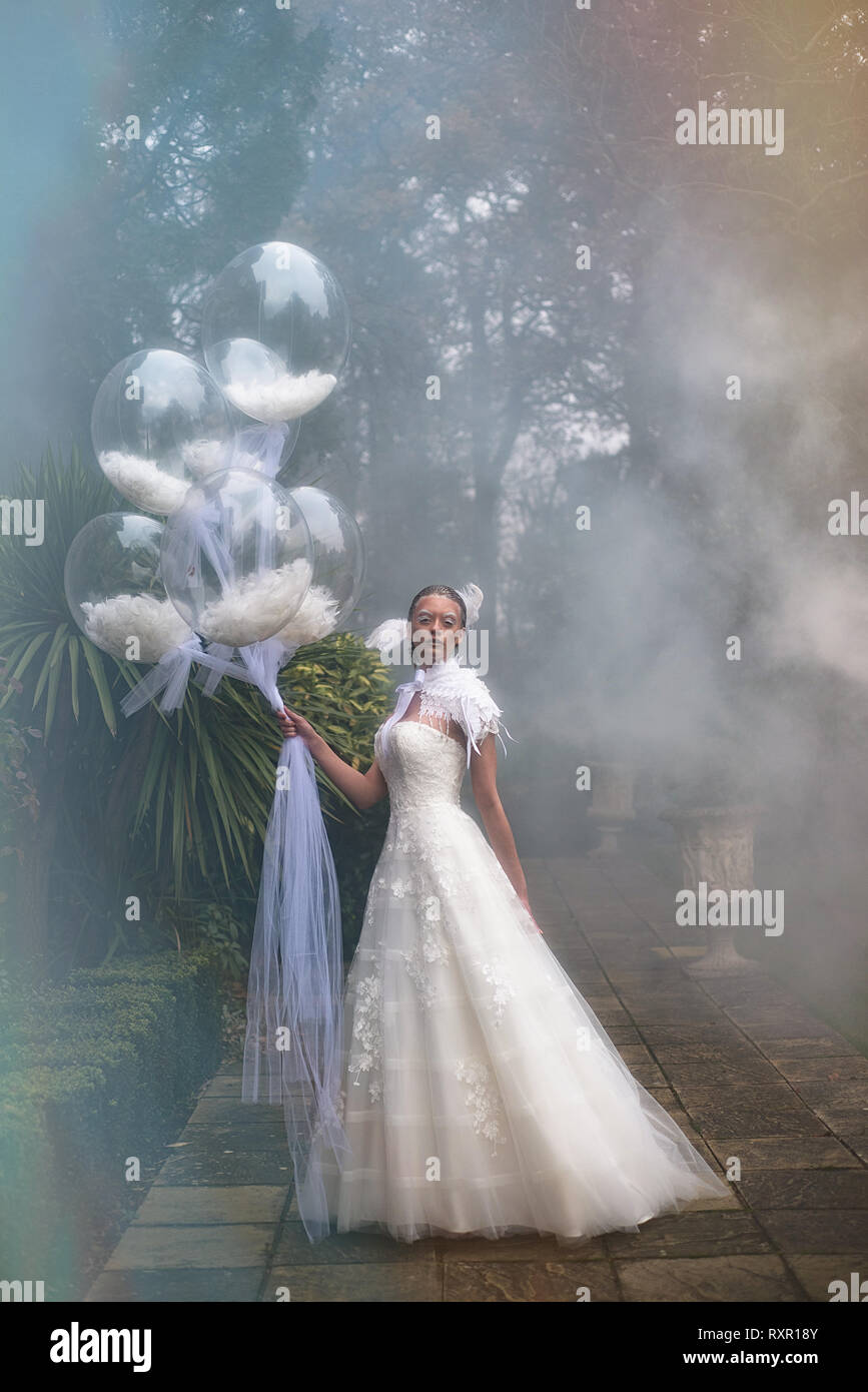 A Beautiful Caucasian Girl In A Long White Dress Poses
