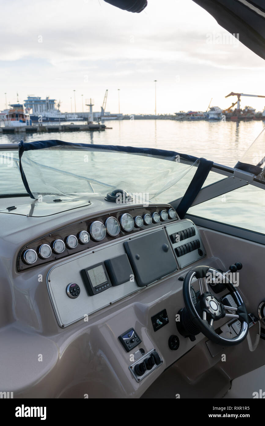 Cockpit and control panel of a small marine boat in the harbor Stock