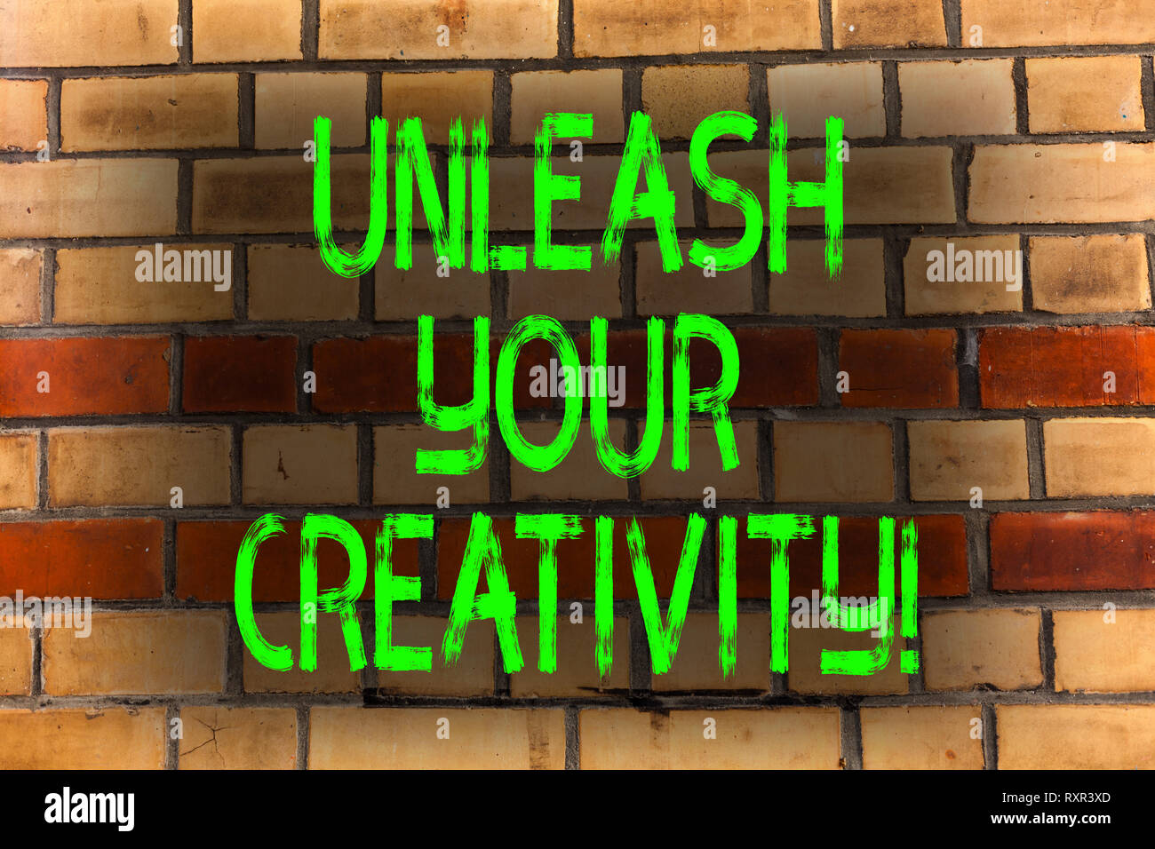 Word writing text Unleash Your Creativity. Business photo showcasing Develop Personal Intelligence Wittiness Wisdom Brick Wall art like Graffiti motiv Stock Photo