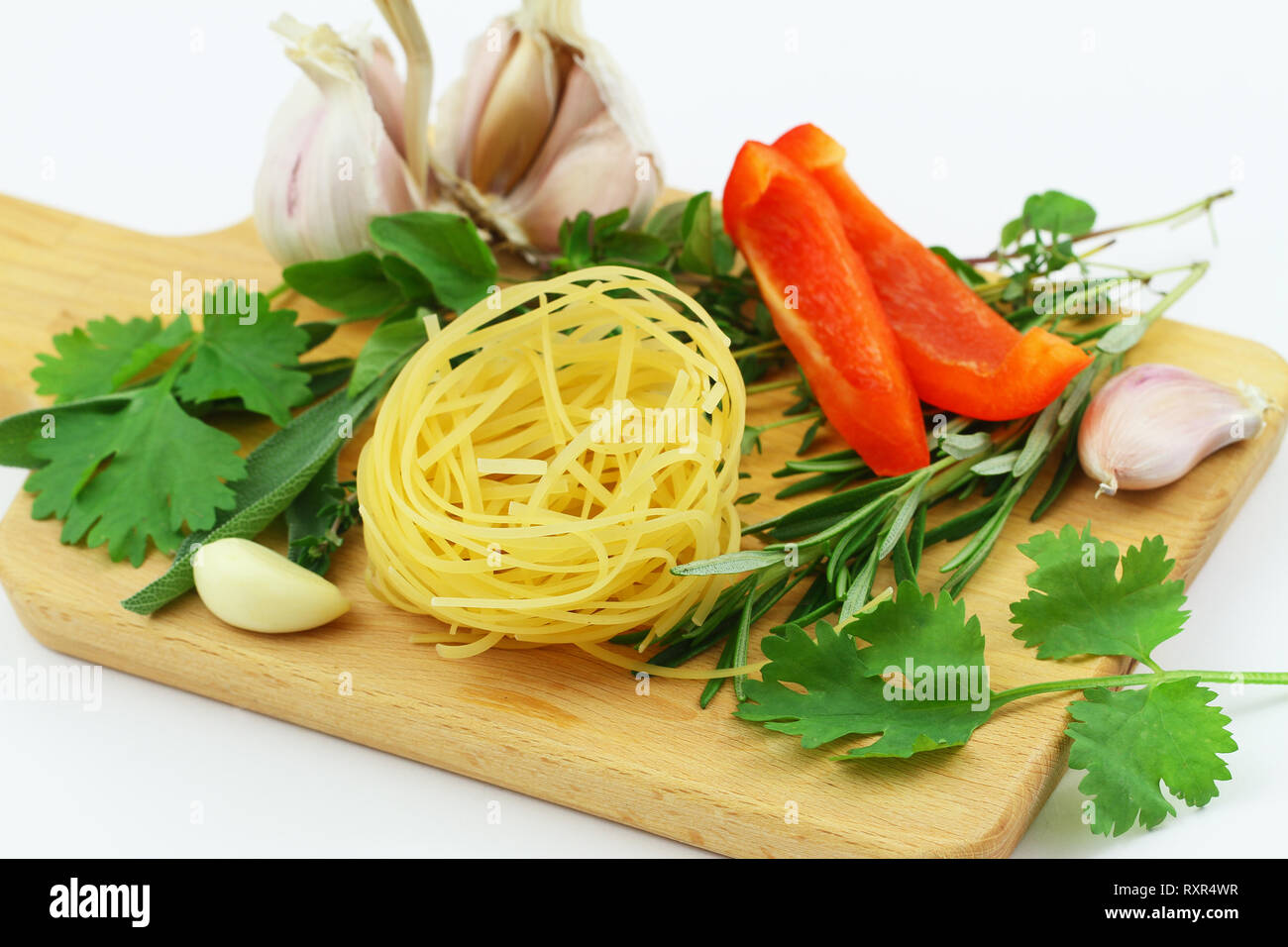 Selection of ingredients for pasta on wooden board, closeup Stock Photo