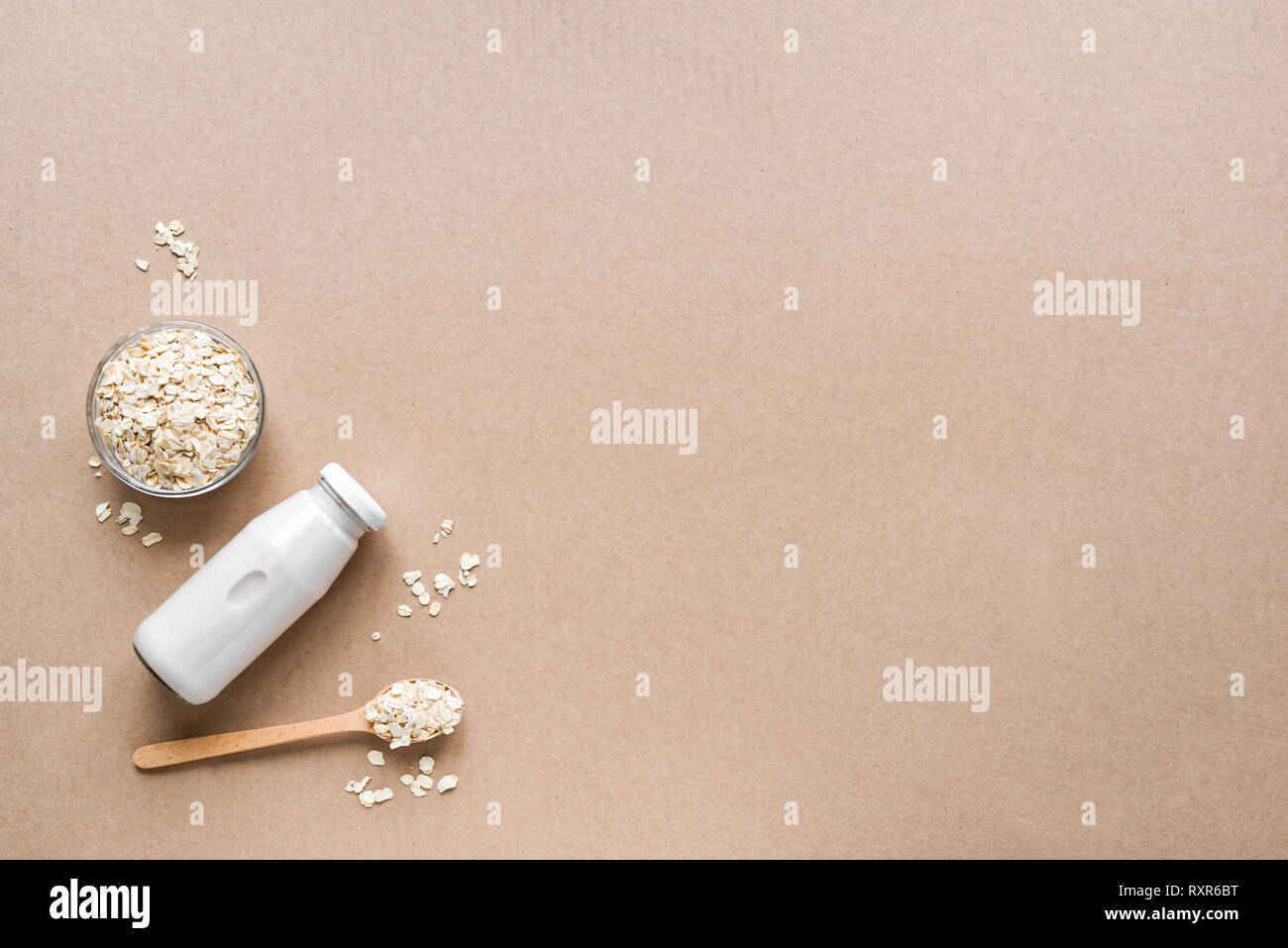 Oat milk alternative on beige background, copy space, top view. Healthy