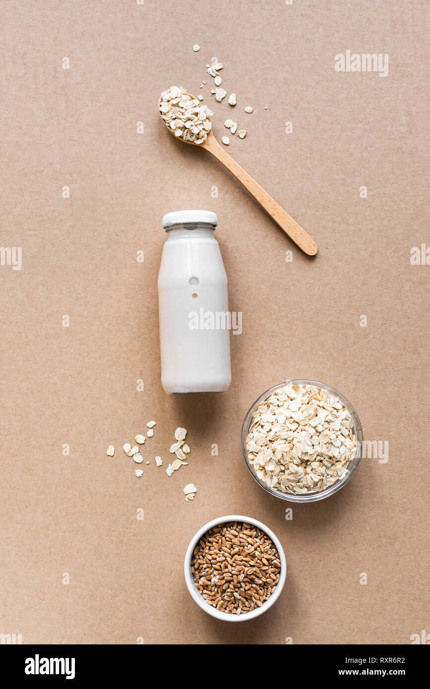Oat milk alternative on beige background, copy space, top view. Healthy