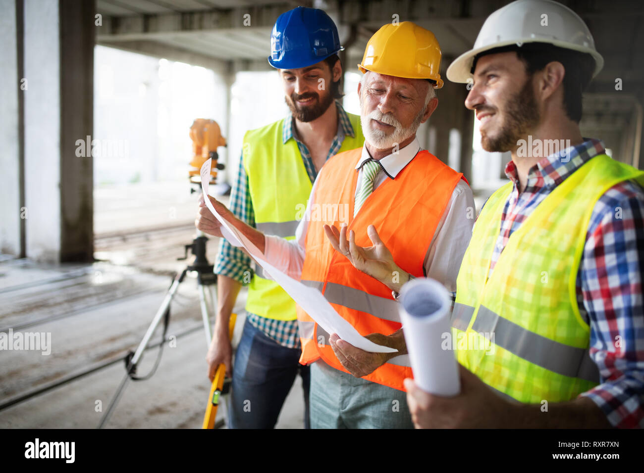 Engineer and construction site manager dealing with blueprints and ...
