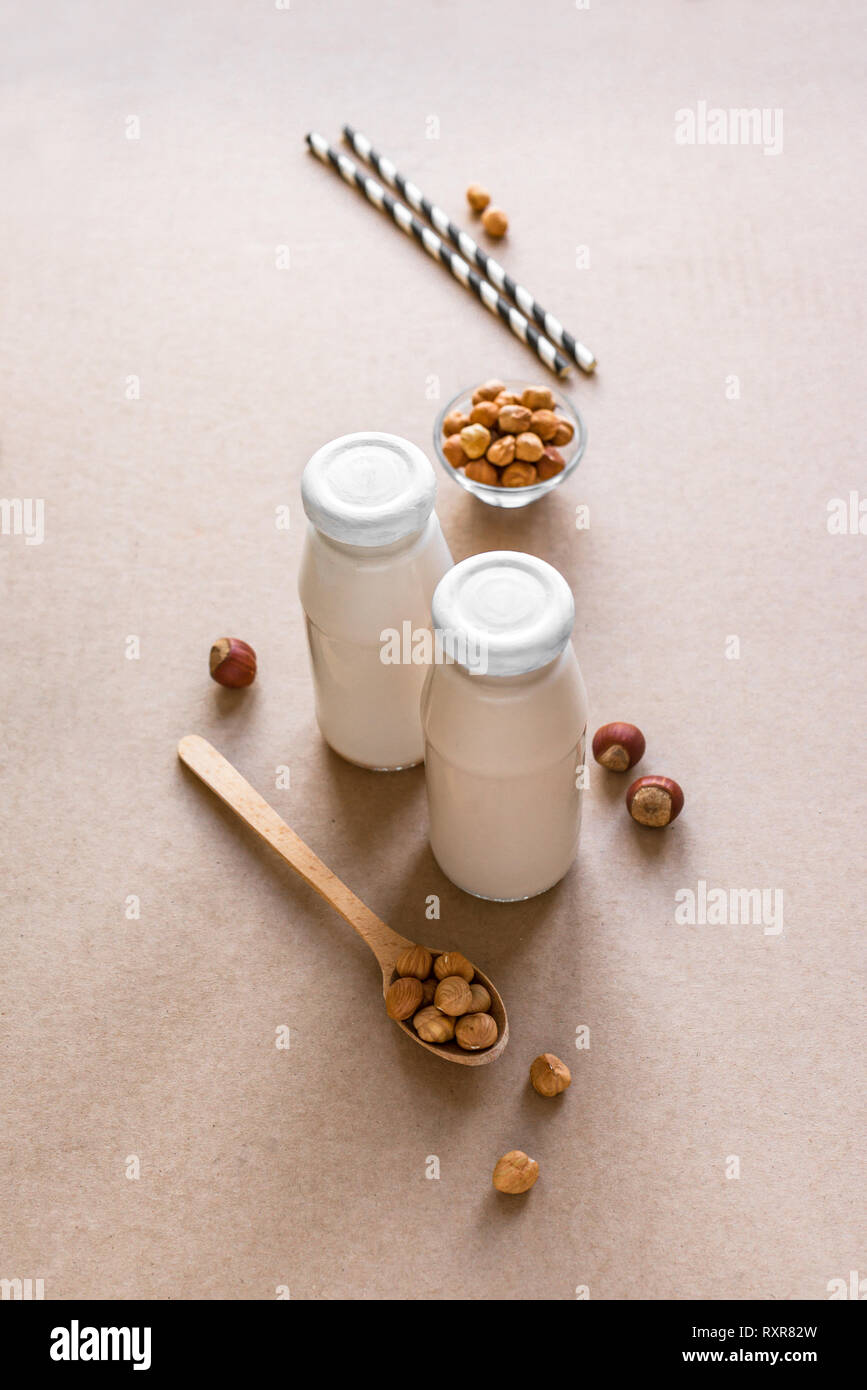 Hazelnut Milk on beige background, copy space. Healthy vegan