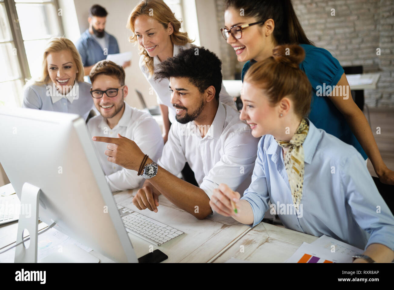 Group of business professionals having a meeting. Diverse group of designers smiling at the office. Stock Photo