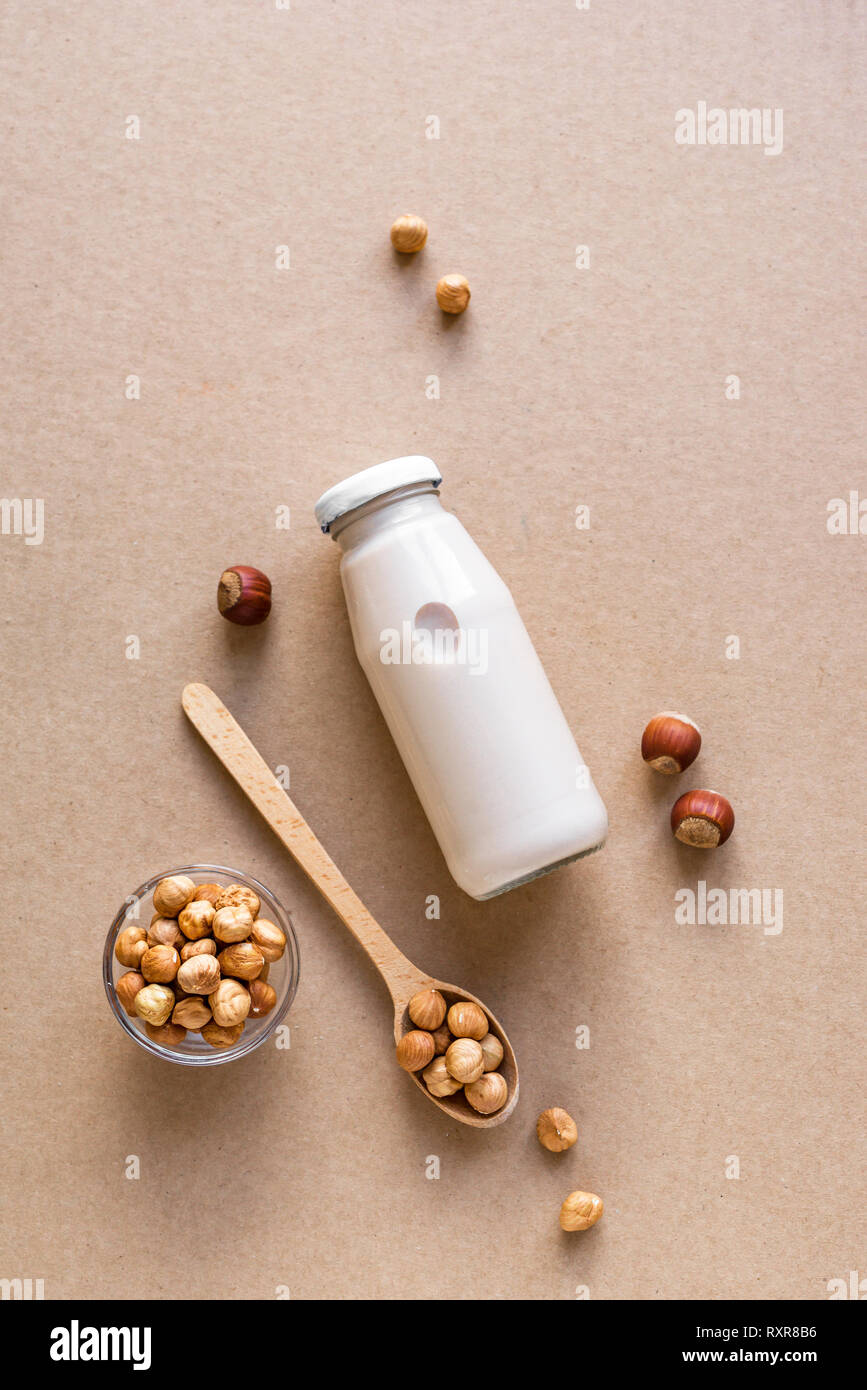 Hazelnut Milk on beige background, copy space. Healthy vegan