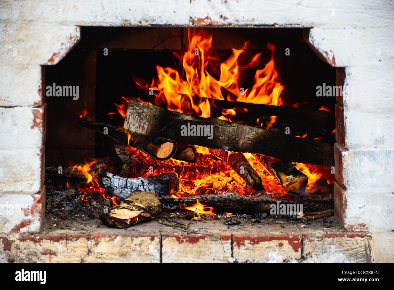 logs are burning in the stove Stock Photo
