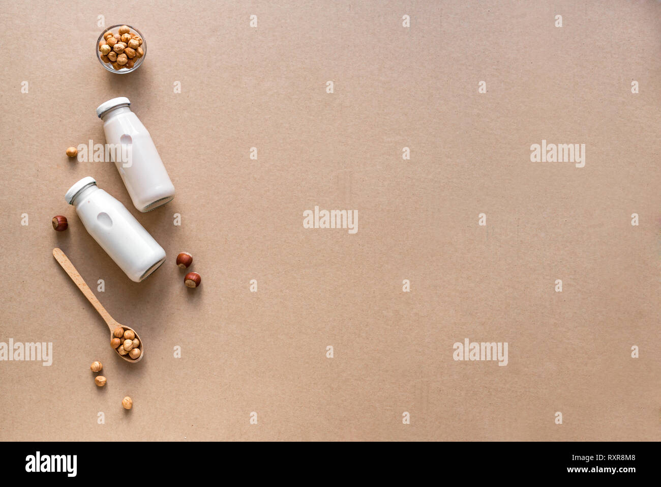 Hazelnut Milk on beige background, copy space. Healthy vegan