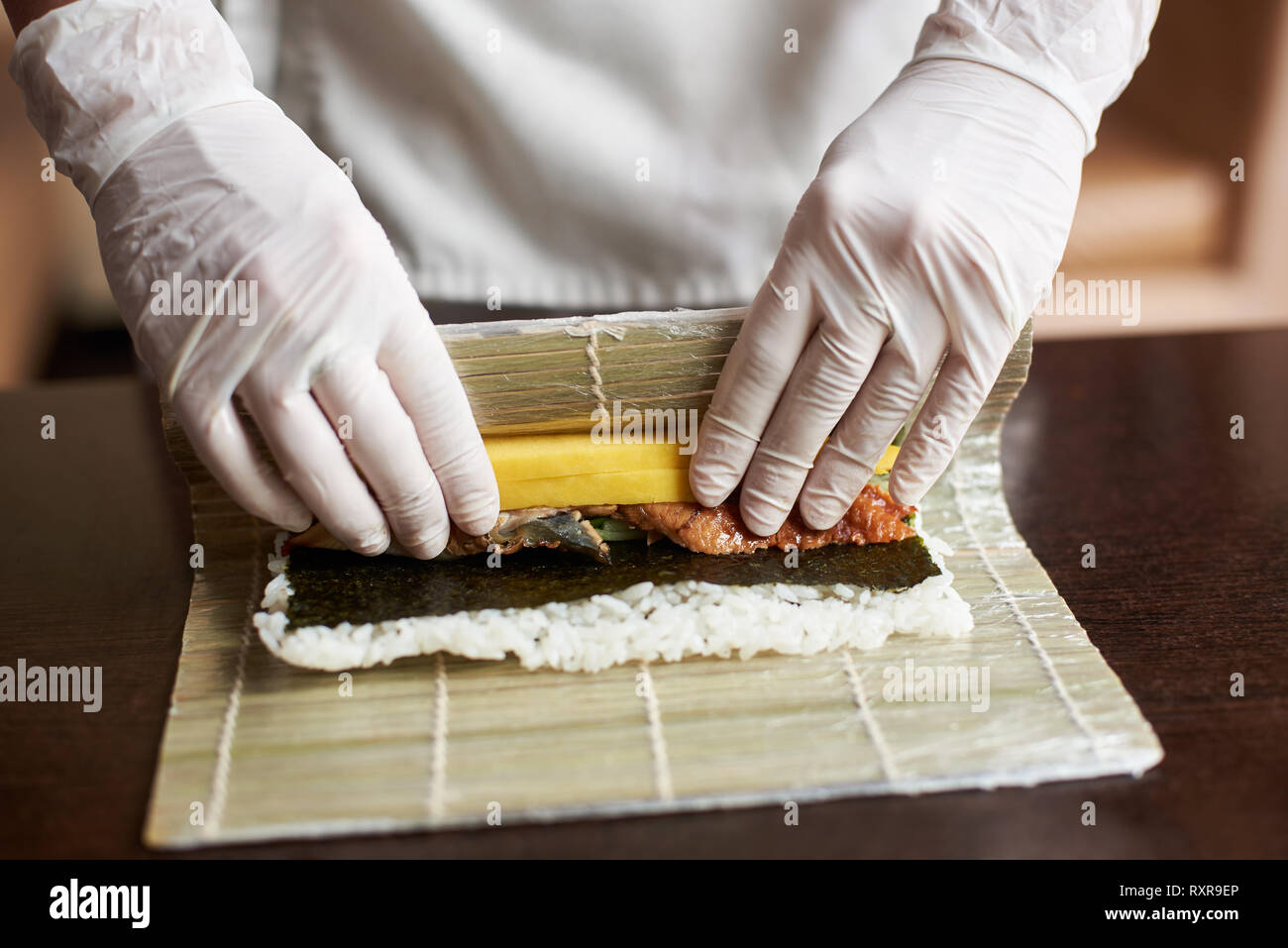 Making Rolled Sushi In A Bamboo Sushi Mat Stock Photo, Picture and