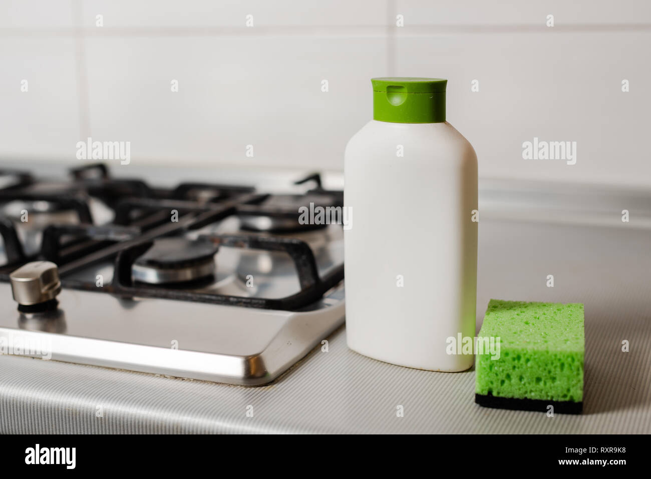Cleaning product in plastic bottle at gas stove Stock Photo Alamy