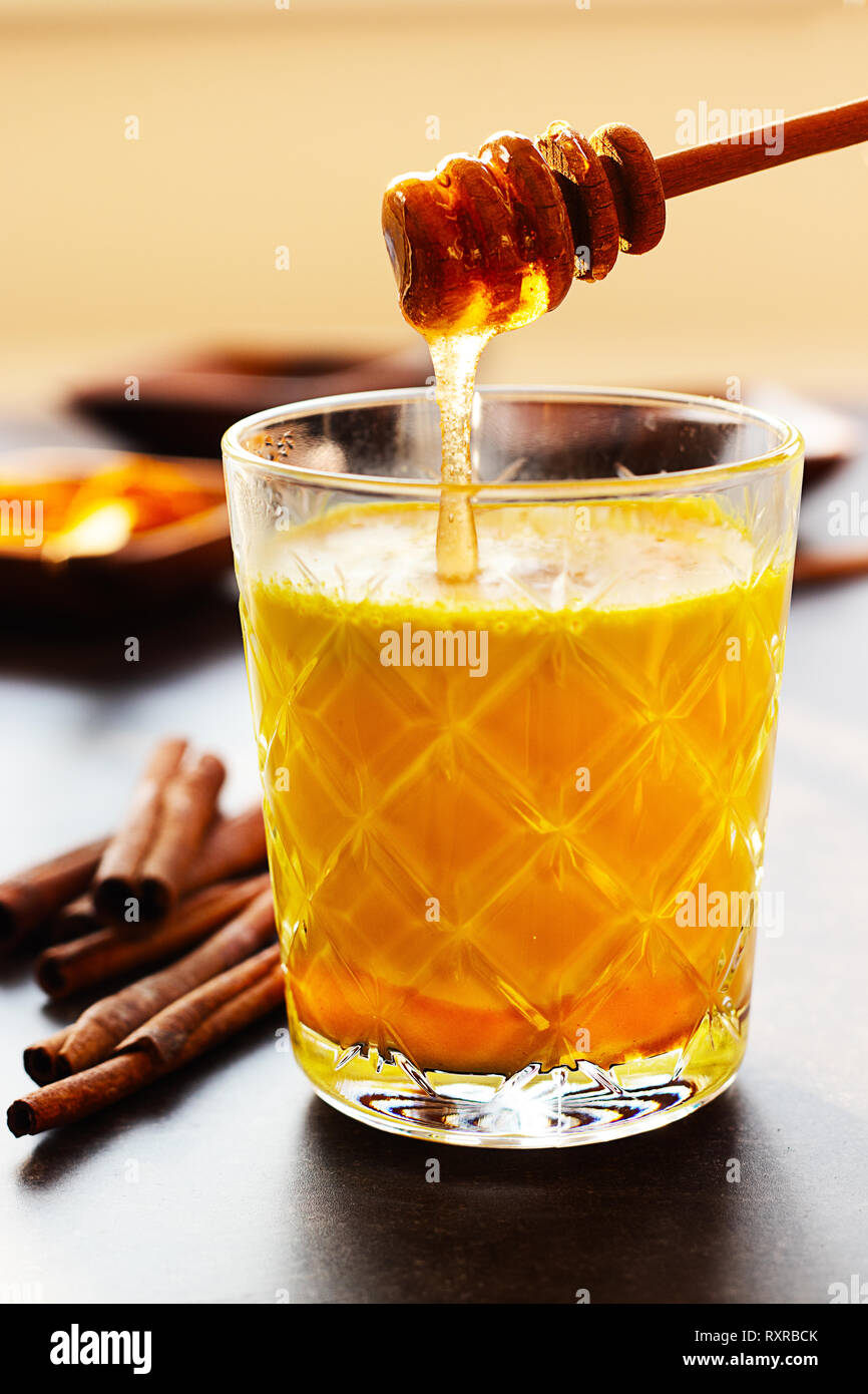 Fresh homemade golden milk with turmeric, cinnamon and honey Stock