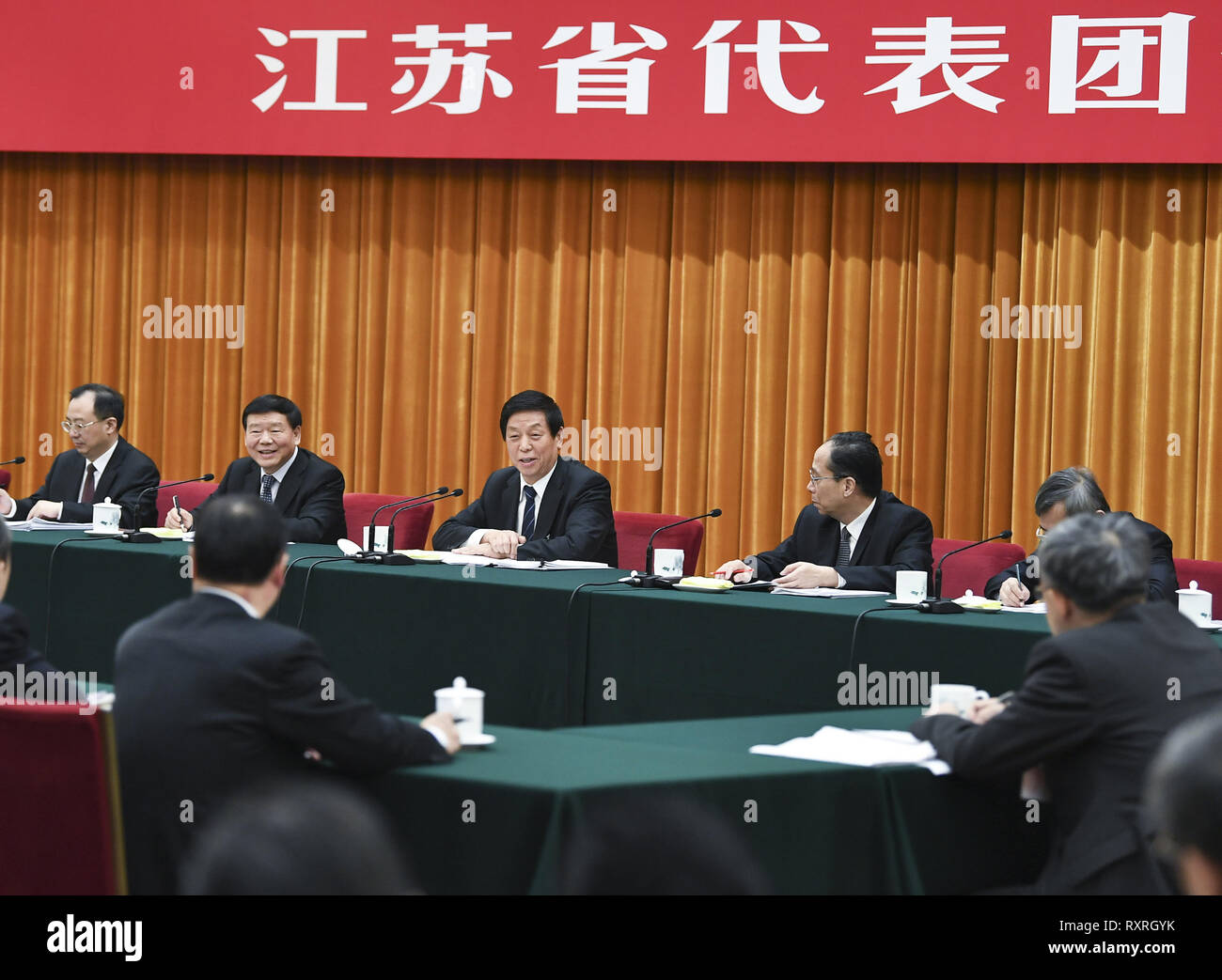 (190310) -- BEIJING, March 10, 2019 (Xinhua) -- Li Zhanshu, a member of the Standing Committee of the Political Bureau of the Communist Party of China (CPC) Central Committee and chairman of the National People's Congress (NPC) Standing Committee, deliberates with the delegation from Jiangsu Province at the second session of the 13th NPC in Beijing, capital of China, March 10, 2019. (Xinhua/Xie Huanchi) Stock Photo