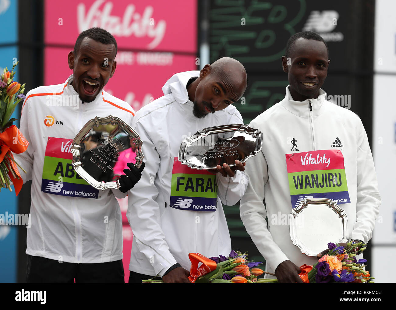 London, UK. 10th Mar 2019. The Vitality Big Half Marathon; Winner Sir Mo  Farah poses with the 1st place winners plate alongside 2nd place Bashir  Abdi and 3rd place Daniel Wanjiru on