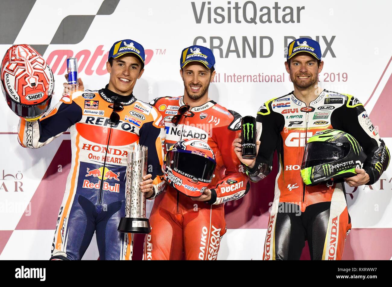 Doha, Qatar. 10th Mar, 2019. Ducati Team's Italian rider Andrea Dovizioso (C), Repsol Honda Team's Spanish rider Marc Marquez (L) and LCR Honda team's British rider Cal Crutchlow pose during the awarding ceremony for the MotoGP race of the 2019 MotoGP Grand Prix of Qatar in Losail Circuit of Doha, capital of Qatar, on March 10, 2019. Andrea Dovizioso claimed the title with 42 minutes and 36.902 seconds. Credit: Nikku/Xinhua/Alamy Live News Stock Photo