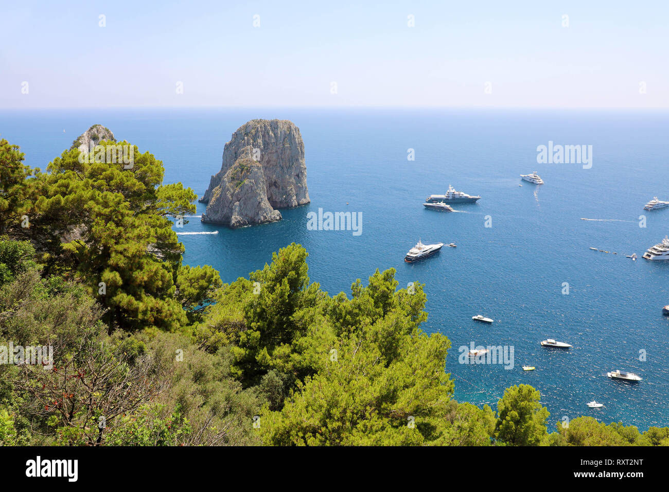 Stunning view of Capri island in a beautiful summer day with Faraglioni ...