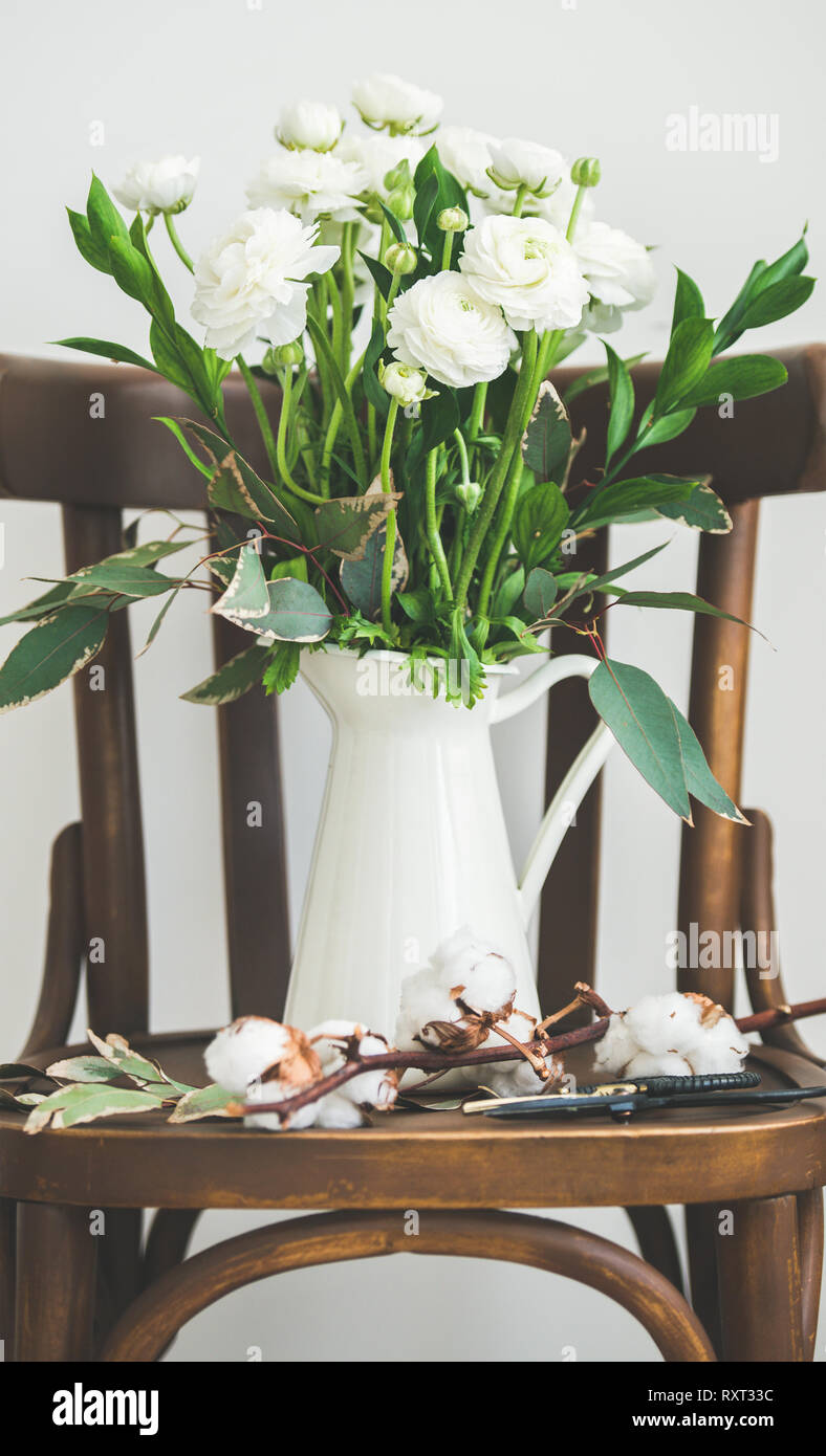 Spring white buttercup flowers in enamel jug on chair Stock Photo Alamy