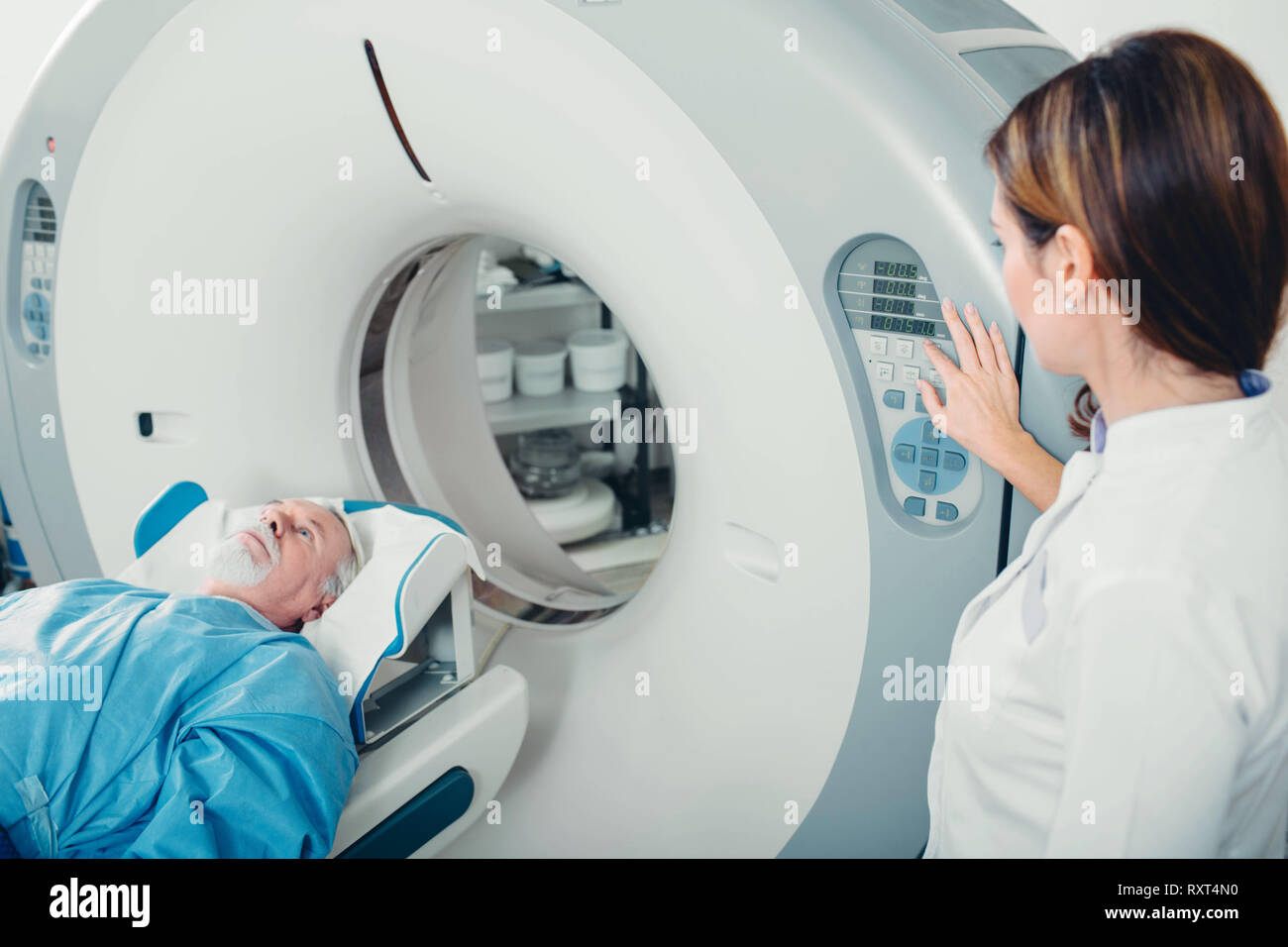 preparing scanner for senior patient , going into CT scanner in hospital Stock Photo