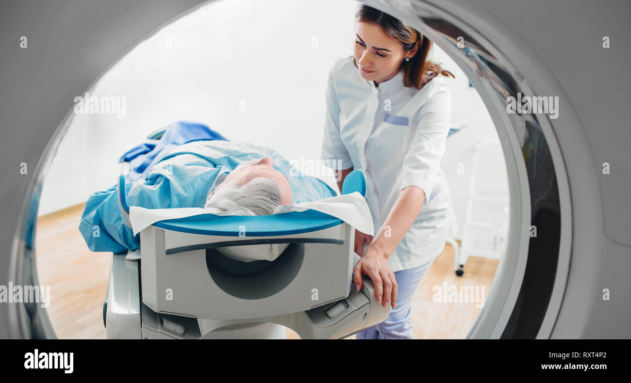 friendly doctor talking to patient . CT Scan in hospital Stock Photo