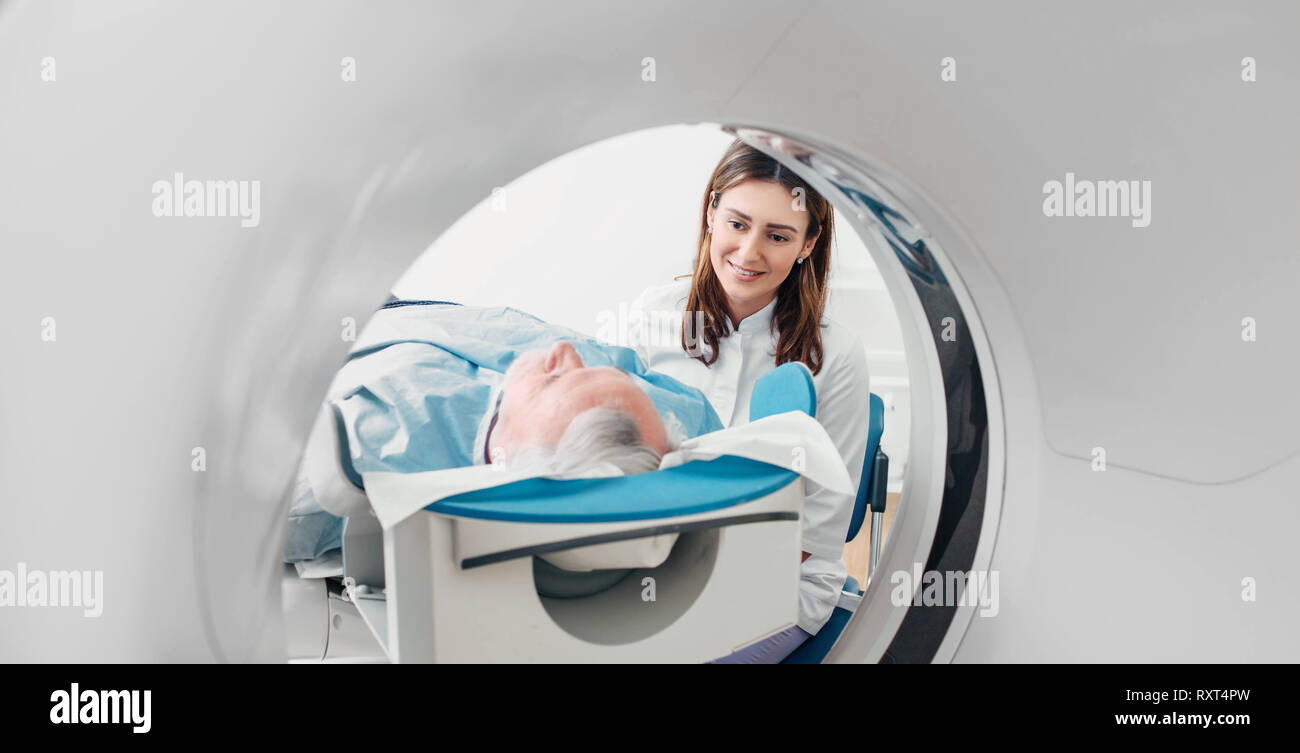 friendly doctor talking to patient . CT Scan in hospital Stock Photo