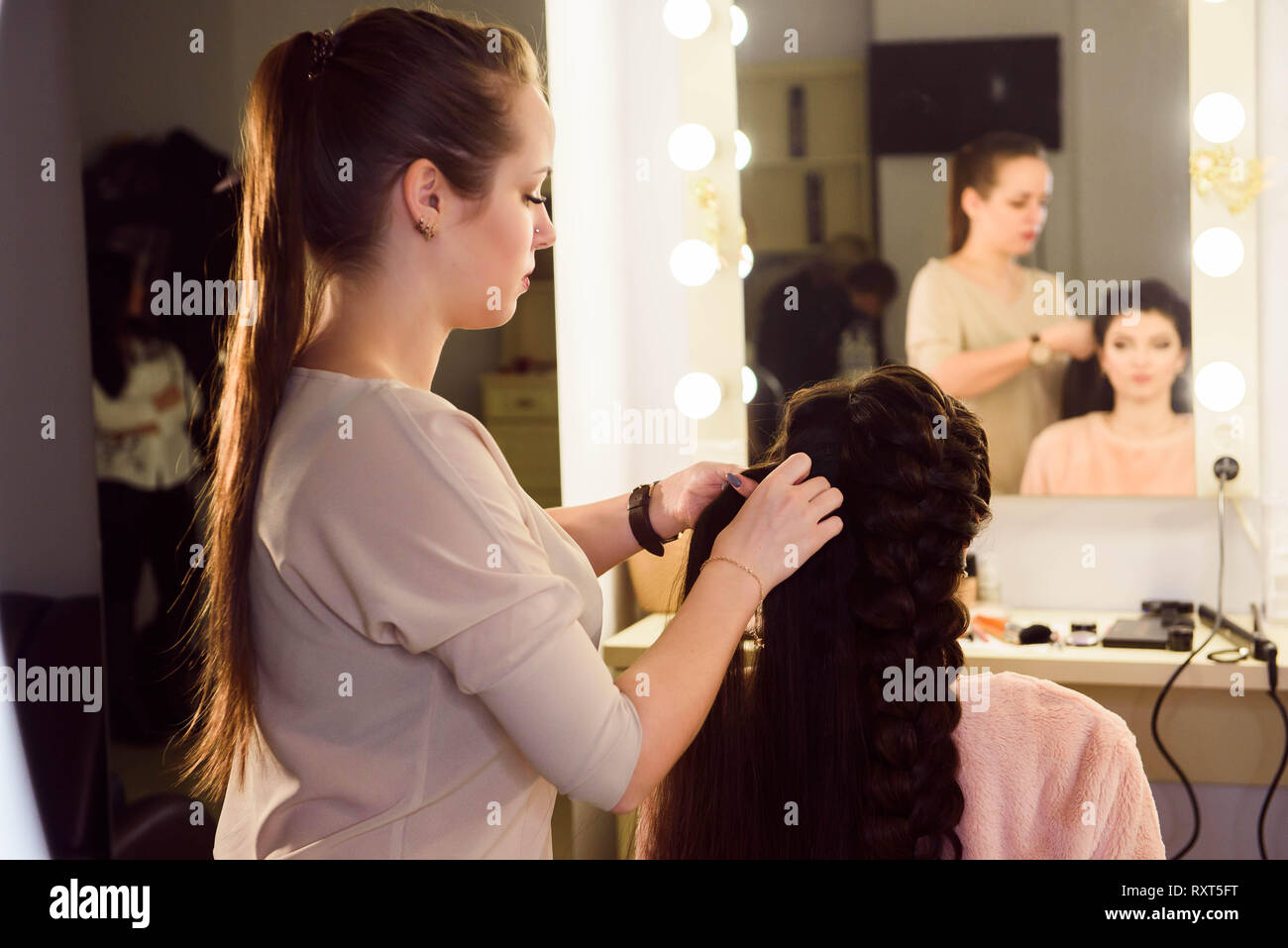 Beautiful Girl With Long Hair Hairdresser Weaves A French Braid