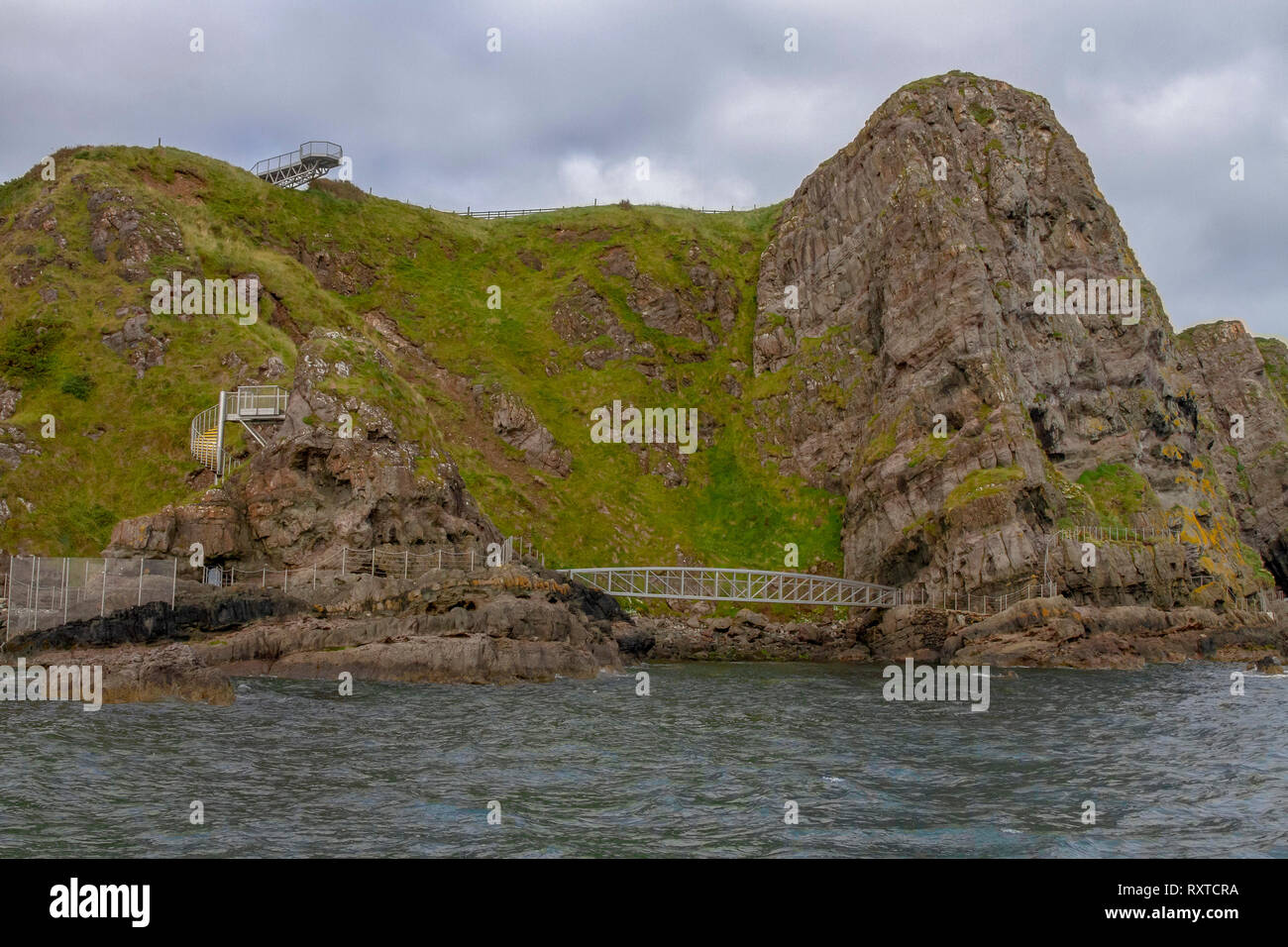 Sea cliff Ireland with bridges and walkways on The Gobbins Cliff Path walk in County Antrim, Northern Ireland. Stock Photo