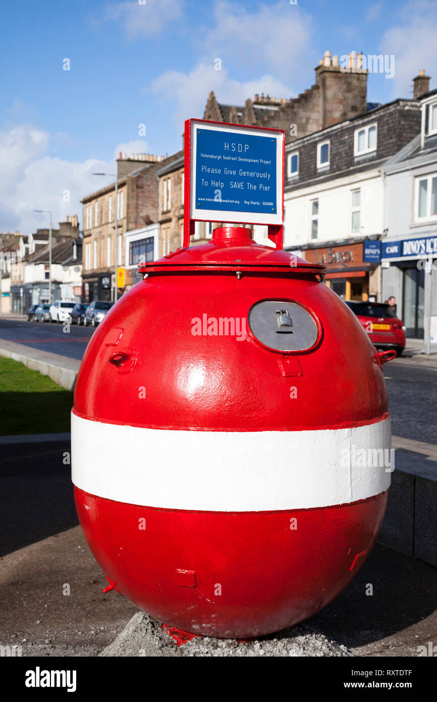 Shell of a World War 2 mine being used as a charity box on West Clyde Street, Helensburgh, Argyll, Scotland Stock Photo