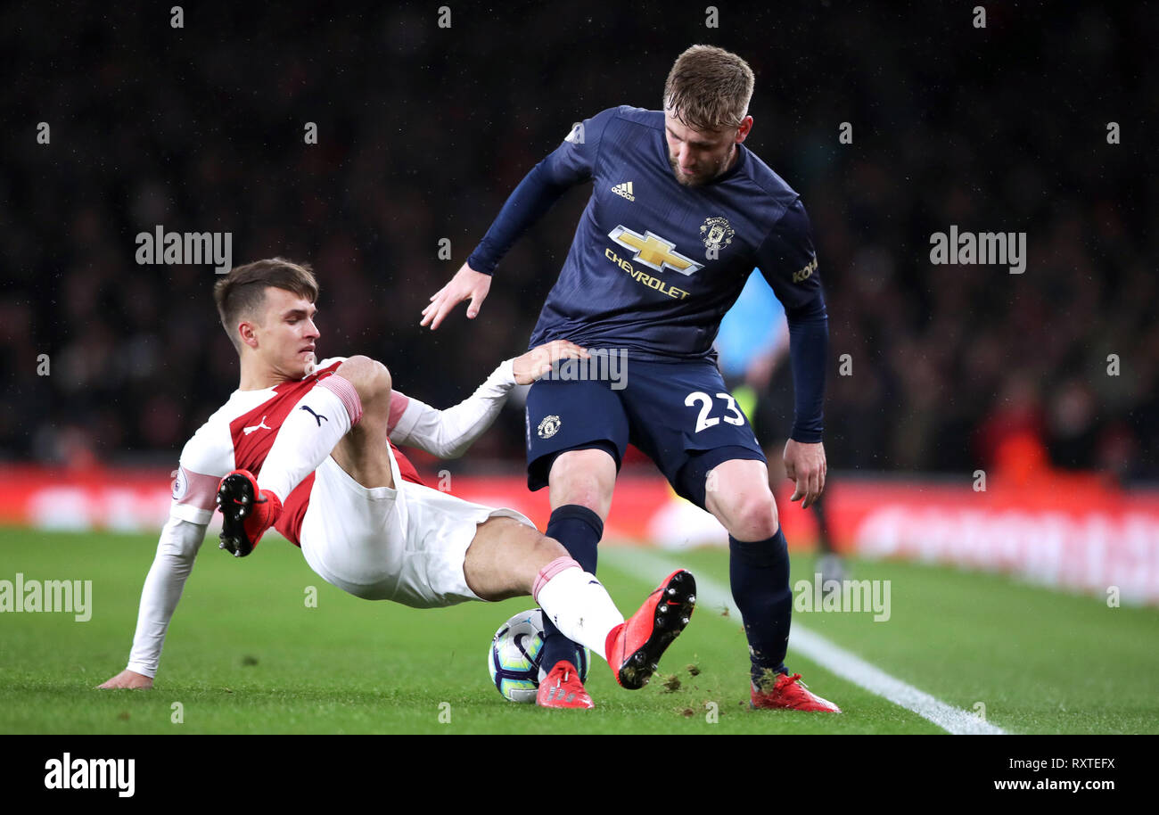 Arsenal's Denis Suarez (left) and Manchester United's Luke Shaw battle for the ball during the Premier League match at the Emirates Stadium, London. Stock Photo