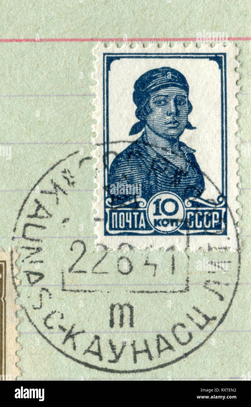 Soviet historical stamp: Female worker in a kerchieft with the cancellation of the first day of the war, June 22, 1941, Russia, Lithuania, USSR, wwii Stock Photo