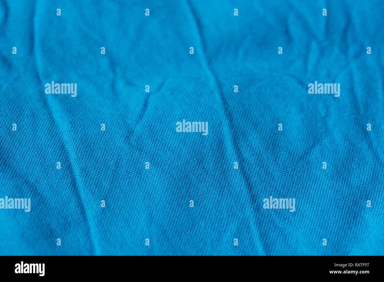 creased blue color  textile texture background selective focus Stock Photo