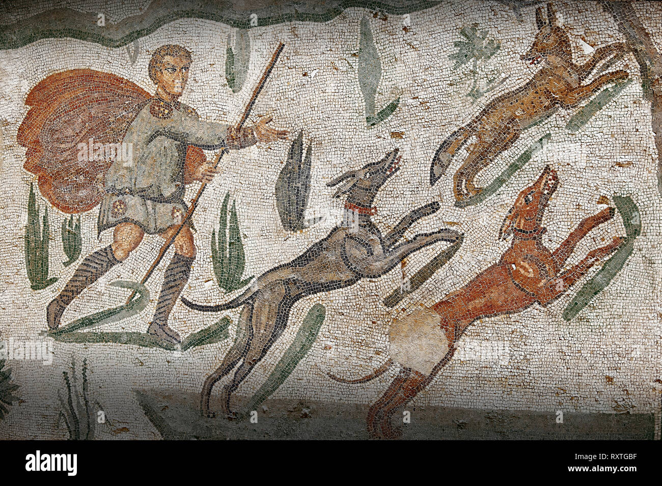 Hunter with dogs chasing a fox from the Room of The Small Hunt, no 25 - Roman mosaics at the Villa Romana del Casale 4th century AD. Sicily, Italy. A  Stock Photo