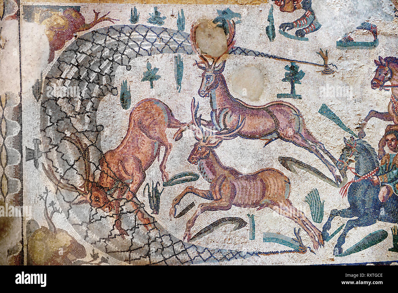 Hunter driving deer into a net from the Room of The Small Hunt, no 25 - Roman mosaics at the Villa Romana del Casale which containis the richest, larg Stock Photo