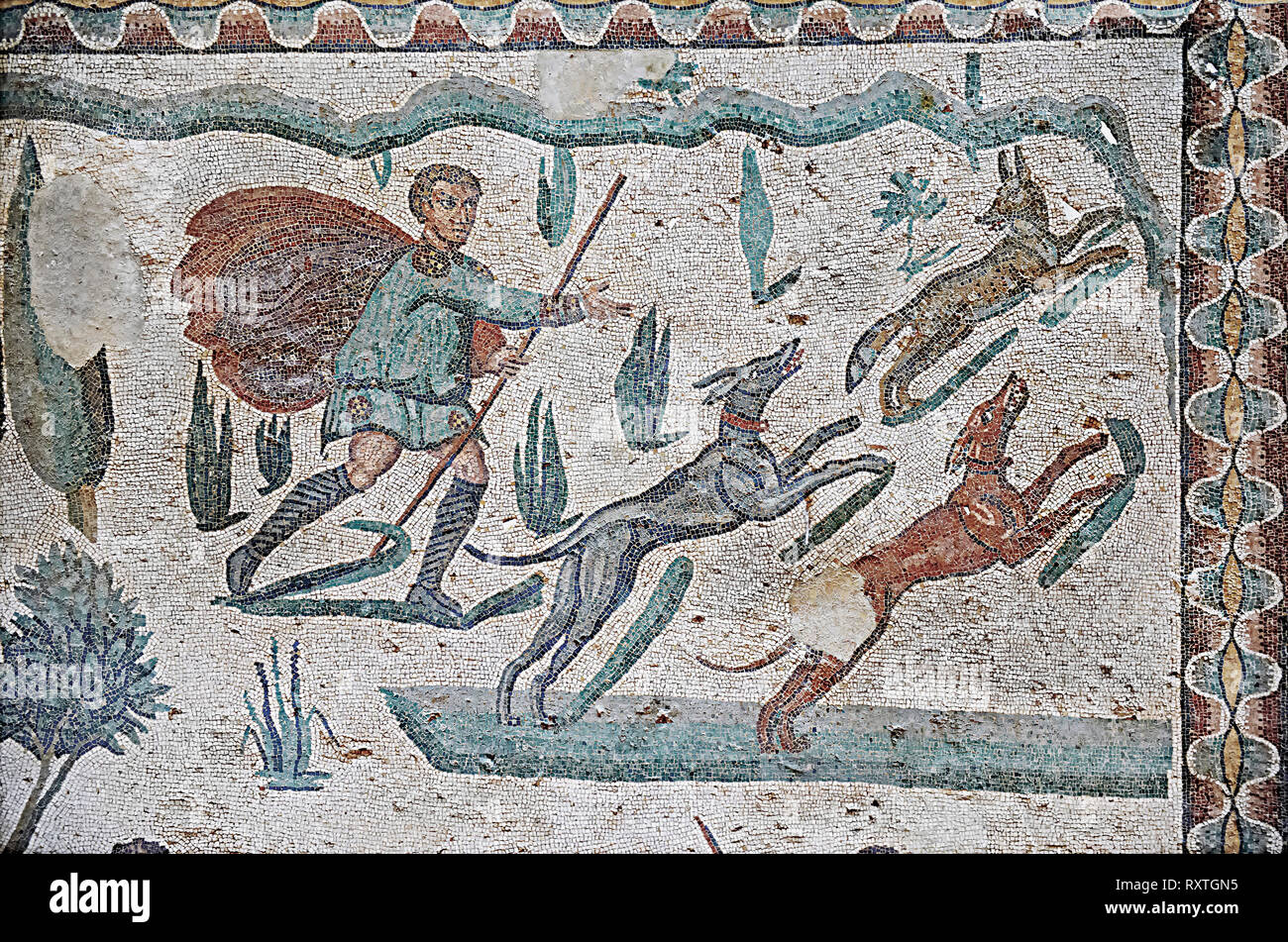 Hunter awith dogs chasing a fox from the Room of The Small Hunt, no 25 - Roman mosaics at the Villa Romana del Casale which containis the richest, lar Stock Photo