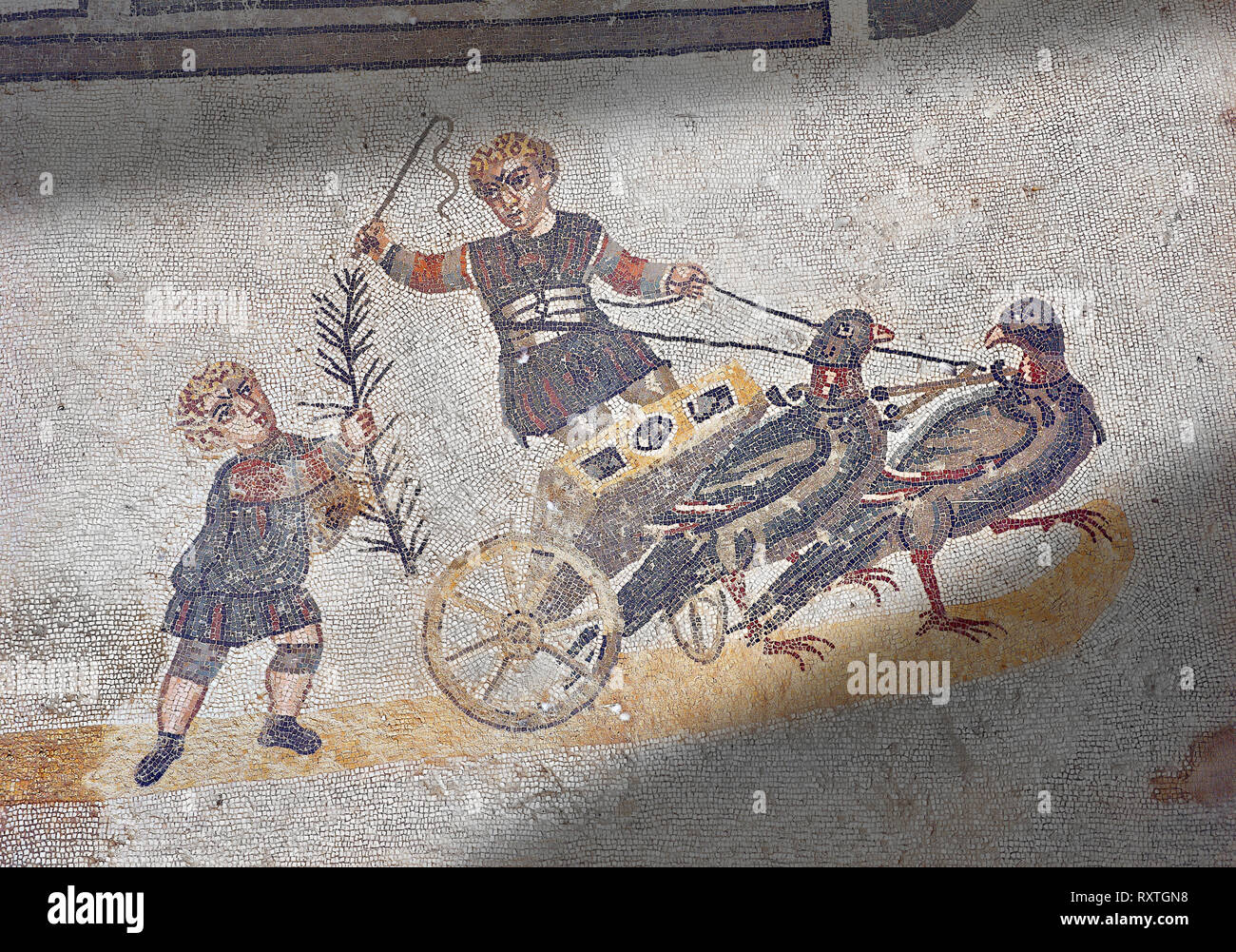Roma children's chariot race from The Vestibule of The Smnall Circus, room no 41 - Roman mosaics at the Villa Romana del Casale,  circa the first quar Stock Photo