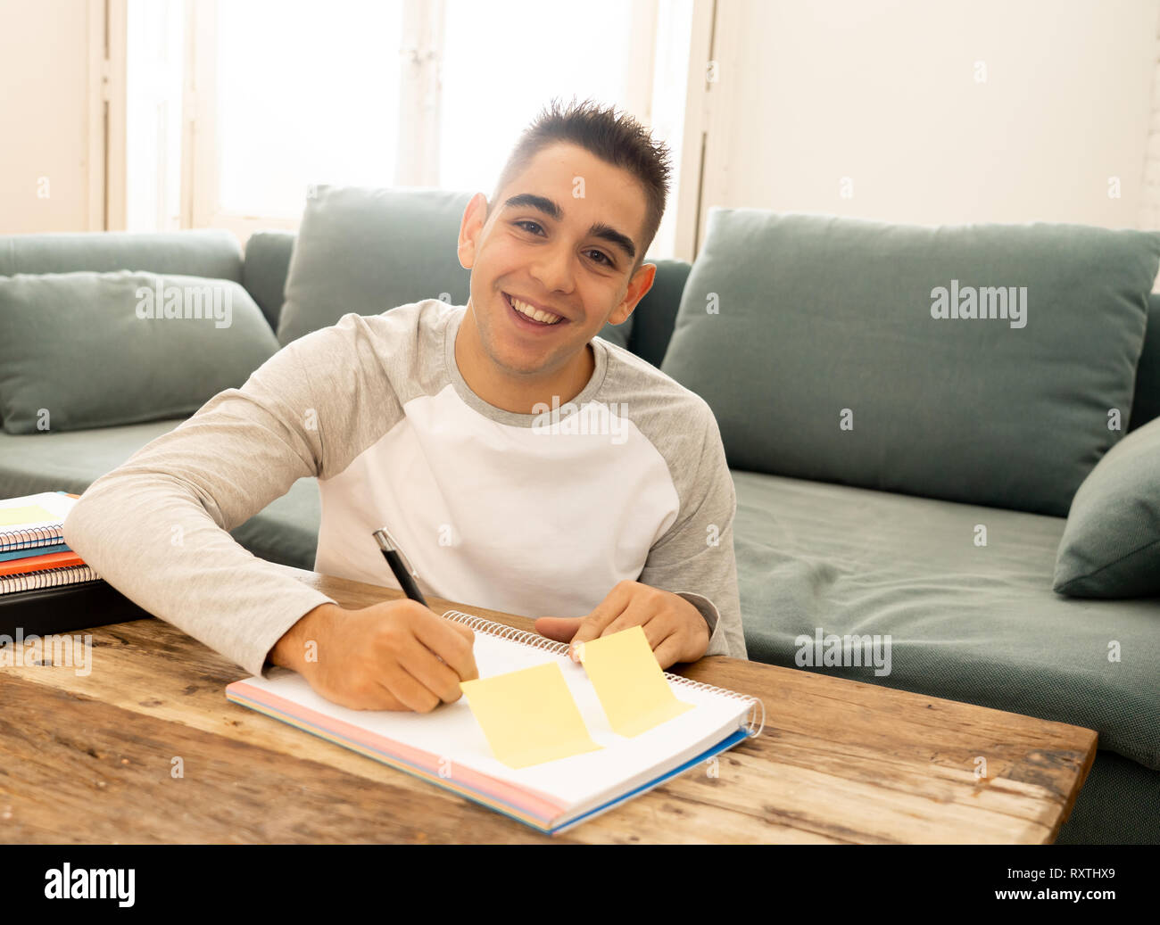 Portrait of happy young student man in his twenties working, studying ...