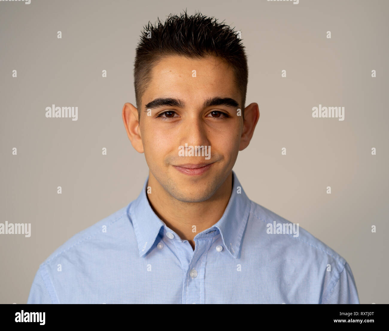 Close up portrait of attractive, confident young man looking neutral